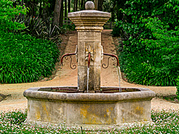 antique pool fountain with a gargoyle head